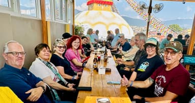 People enjoying a meal at a rooftop restaurant